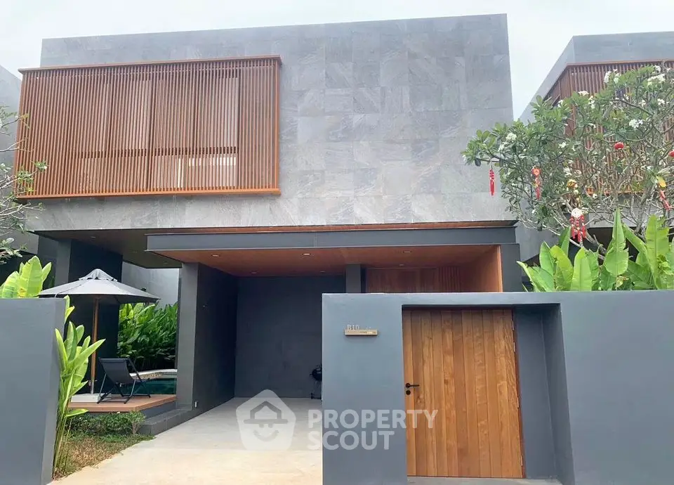Modern minimalist house exterior with sleek design and lush greenery