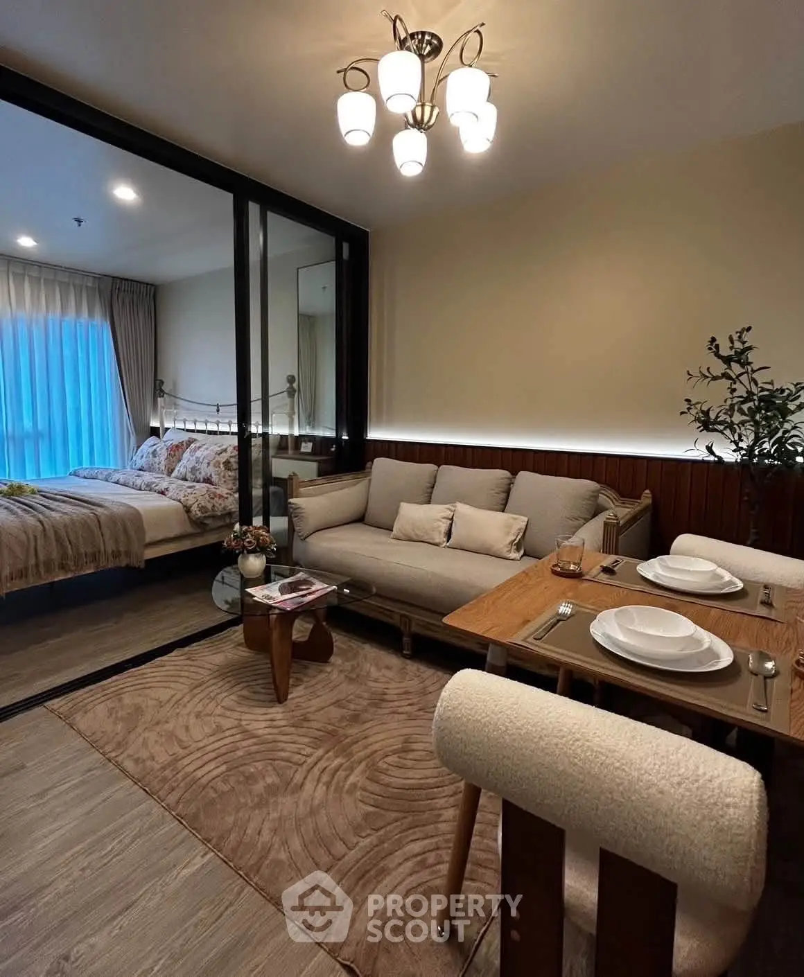 Cozy living room with dining area and view into a stylish bedroom, perfect for modern living.