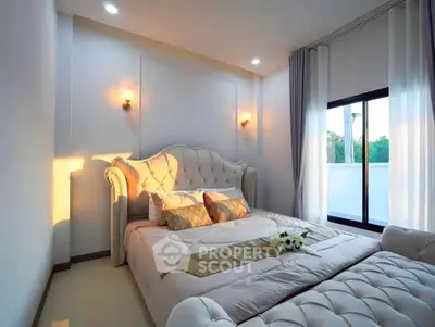 Luxurious bedroom with elegant decor and large window offering natural light.