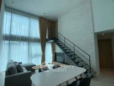 Stunning modern living room with high ceilings and sleek staircase