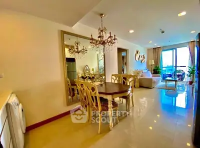 Luxurious open-plan living room with elegant dining area and modern decor.