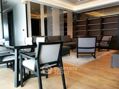 Modern living room with elegant furniture and stylish decor, featuring a spacious layout and wooden flooring.