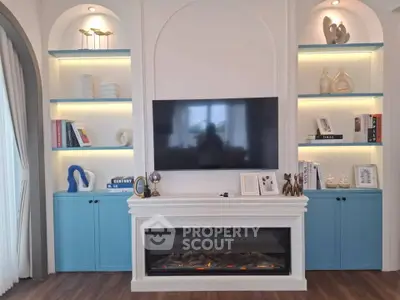 Elegant living room with modern fireplace and stylish built-in shelves.