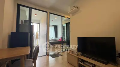 Modern apartment interior with open layout, featuring a cozy living area and a glimpse of the bedroom.