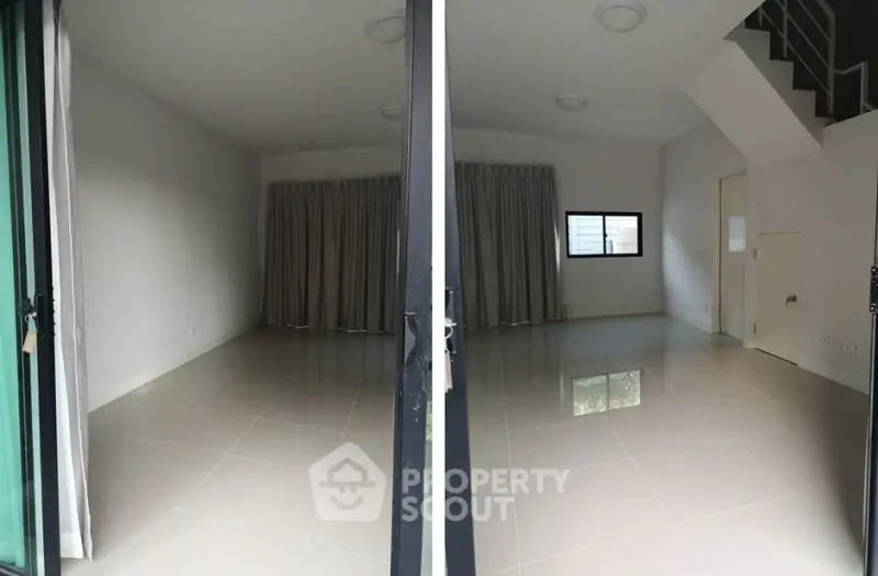Spacious empty room with large windows and staircase, ideal for customization.