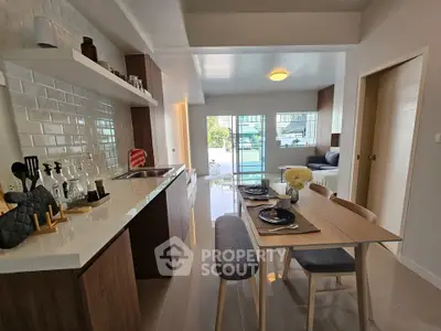 Modern open-plan kitchen and dining area with stylish decor and natural light.