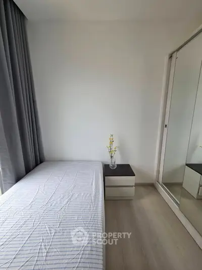 Minimalist bedroom with mirrored wardrobe and elegant decor