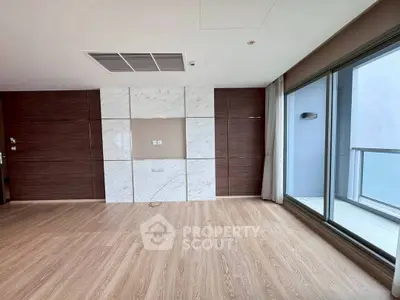 Spacious modern living room with wooden flooring and large windows