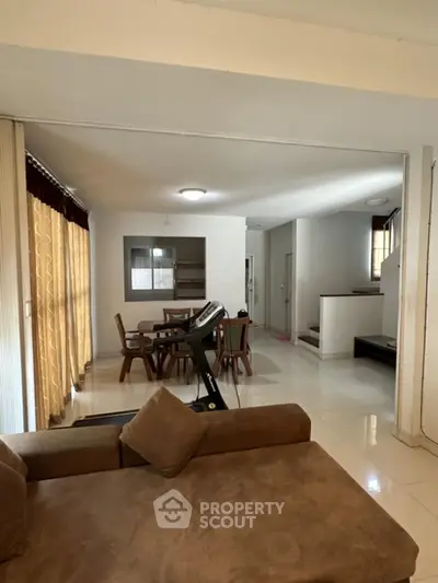 Spacious living room with modern furniture and dining area in open layout