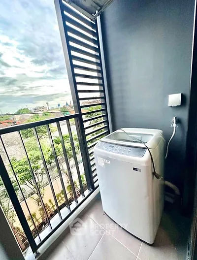 Modern balcony with washing machine and city view, perfect for urban living convenience.