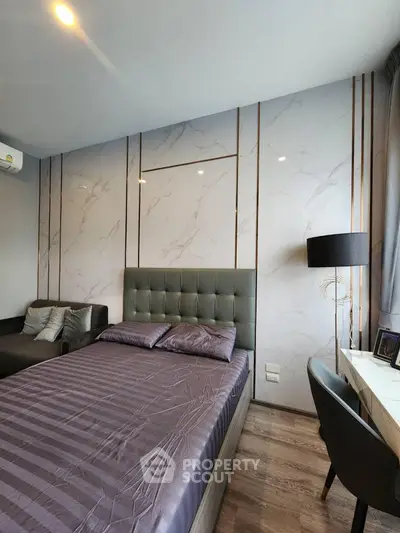 Luxurious bedroom with modern decor and elegant lighting in a stylish apartment.