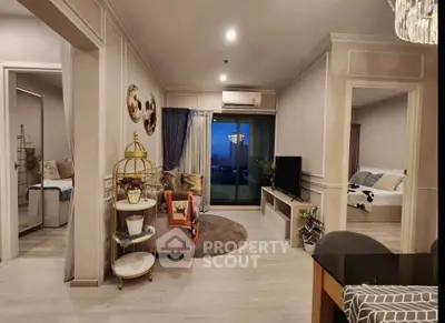 Stylish living room with modern decor and balcony view in a cozy apartment.