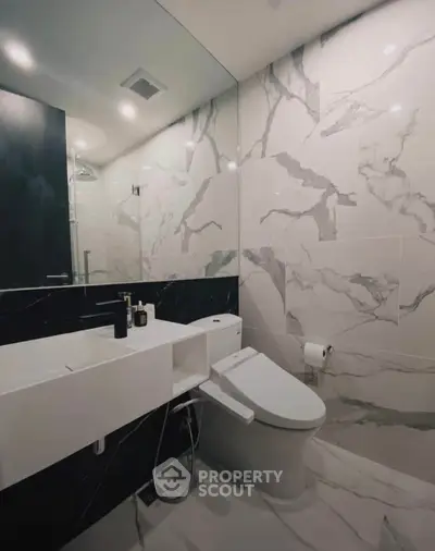 Luxurious modern bathroom with marble tiles and sleek fixtures