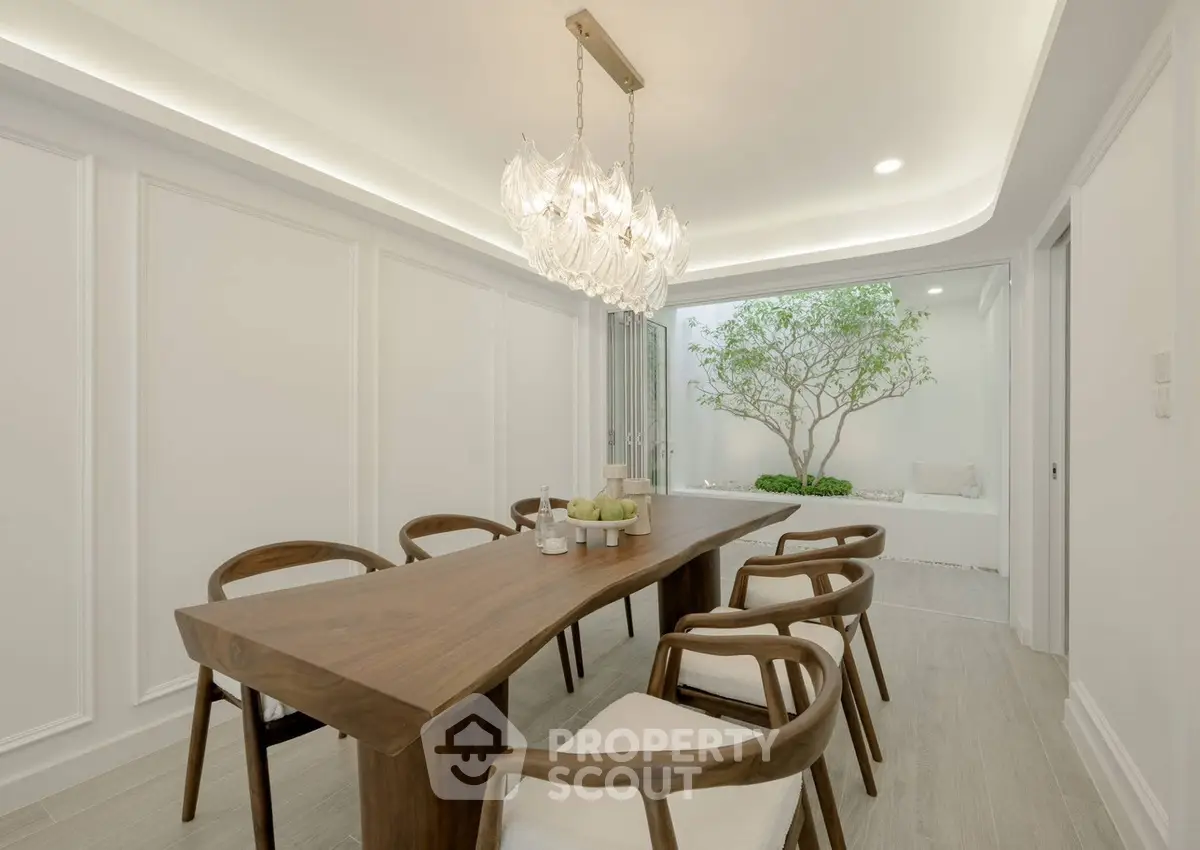 Elegant dining room with modern chandelier and natural light