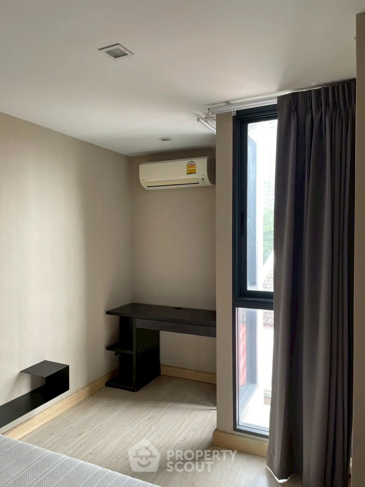 Modern bedroom with large window and air conditioning unit