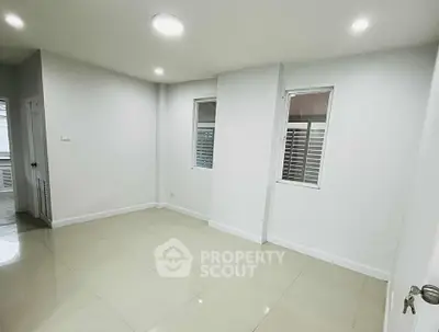 Spacious empty room with tiled flooring and white walls, perfect for customization.