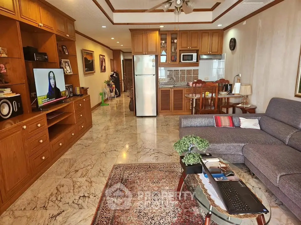 Spacious living room with elegant wooden cabinetry and modern appliances