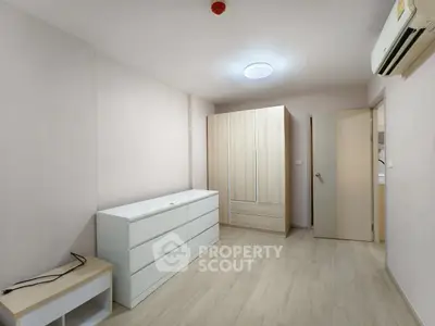 Spacious bedroom with modern wardrobe and air conditioning in minimalist style.