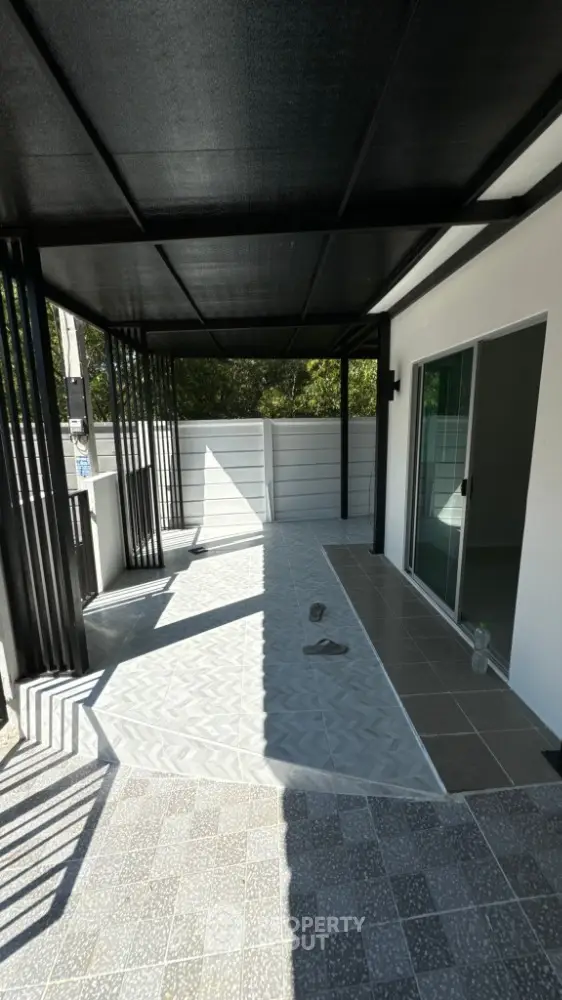Modern covered patio with sleek design and sliding glass doors