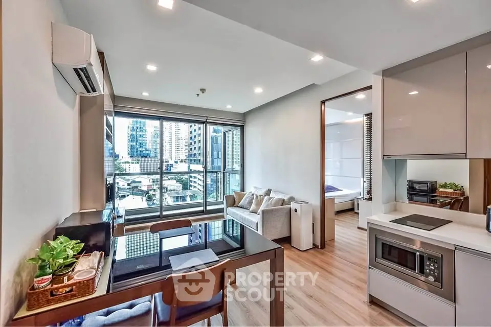 Modern open-plan living room with city view and sleek kitchen design