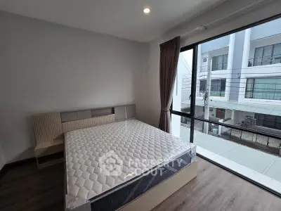 Modern bedroom with large window and stylish bed in a contemporary apartment