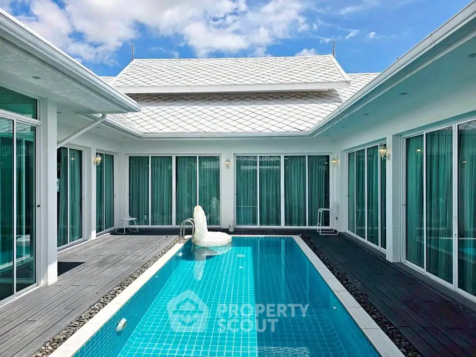 Luxurious modern villa with private pool and elegant architecture under a clear blue sky.