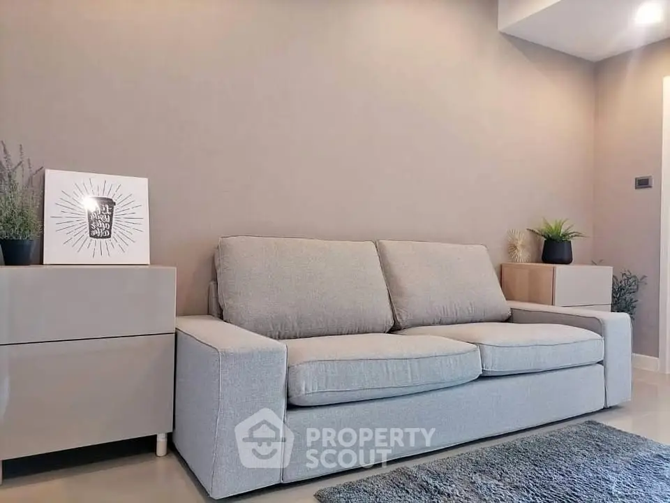 Modern living room with stylish gray sofa and minimalist decor