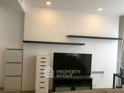 Modern living room with sleek TV setup and minimalist shelving