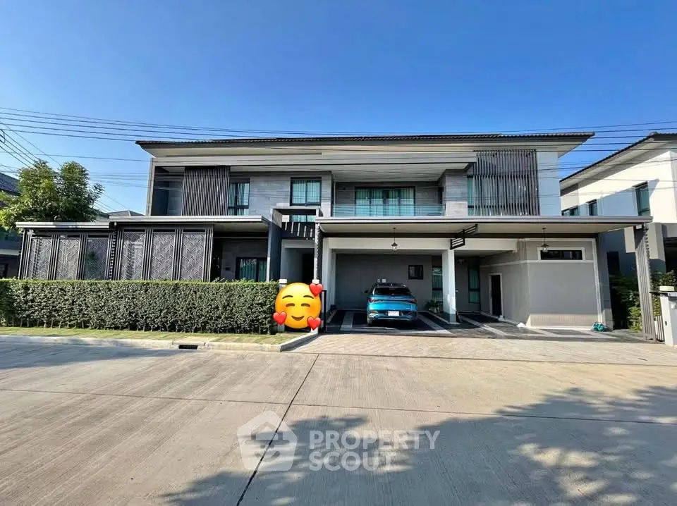 Modern two-story house with carport and sleek design in a suburban neighborhood.