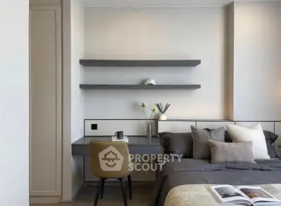 Modern bedroom with sleek desk and shelves, neutral tones, and cozy bedding.