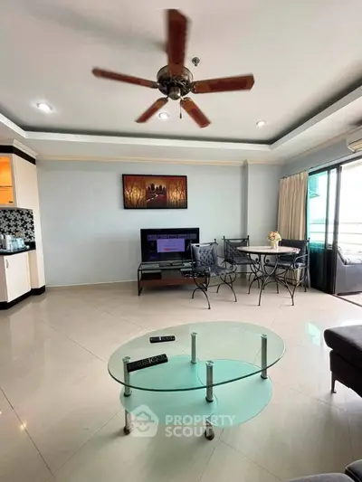 Spacious living room with modern decor and balcony access in a stylish apartment.