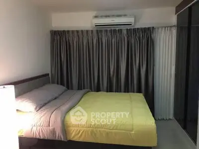 Cozy bedroom with modern air conditioning and elegant curtains, perfect for restful nights.