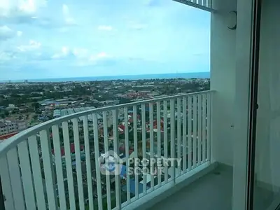 Stunning high-rise balcony with panoramic city and ocean views, perfect for relaxation and enjoying sunsets.