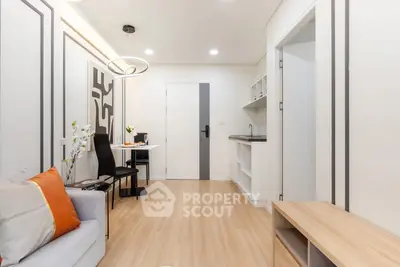 Modern living room with stylish decor and open layout, featuring sleek furniture and contemporary lighting.
