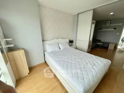 Modern bedroom with wooden flooring and stylish decor in a cozy apartment.