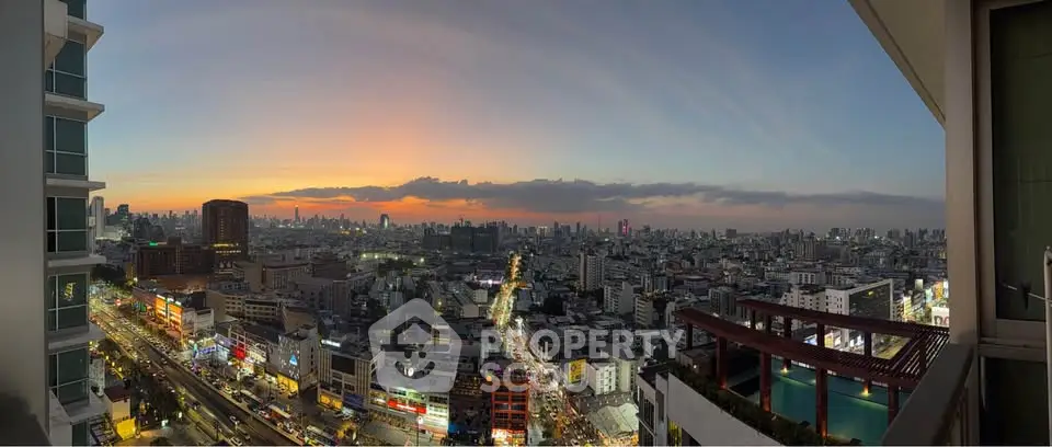 Stunning panoramic city view from high-rise balcony at sunset