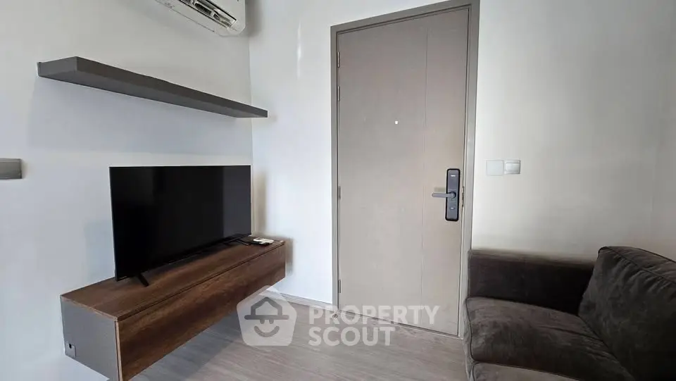 Modern living room with sleek TV setup and stylish sofa, perfect for cozy relaxation.