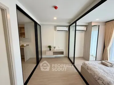Modern bedroom with glass partitions and air conditioning in a stylish apartment.