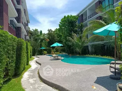 Luxurious apartment complex with a stunning outdoor pool and lush greenery.