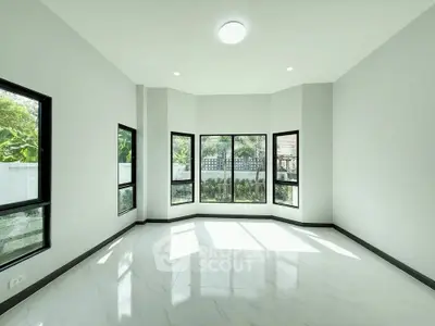 Spacious and bright living room with large windows and modern design