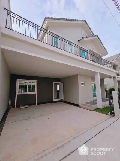 Modern two-story house with spacious driveway and balcony