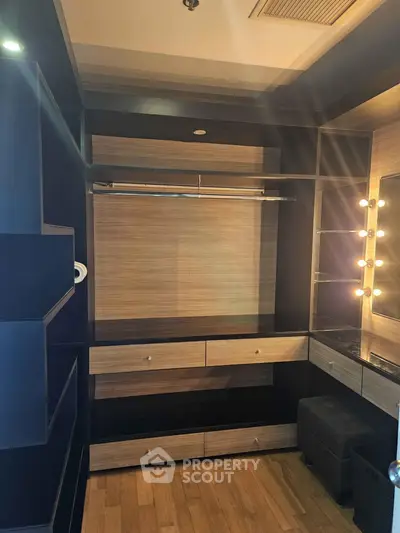Luxurious walk-in closet with elegant lighting and ample storage space