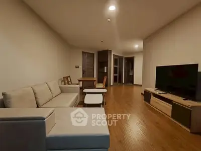 Spacious living room with modern furniture and wooden flooring
