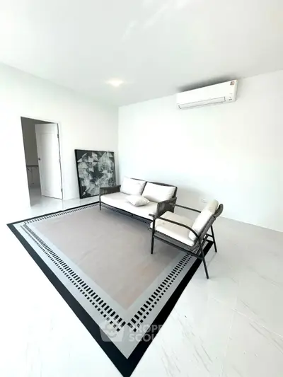 Modern minimalist living room with sleek furniture and air conditioning, perfect for contemporary living.