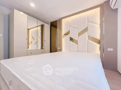 Modern bedroom with stylish geometric wall design and built-in wardrobe