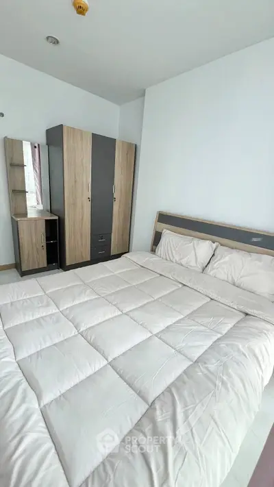 Modern bedroom with cozy bedding and sleek wardrobe design