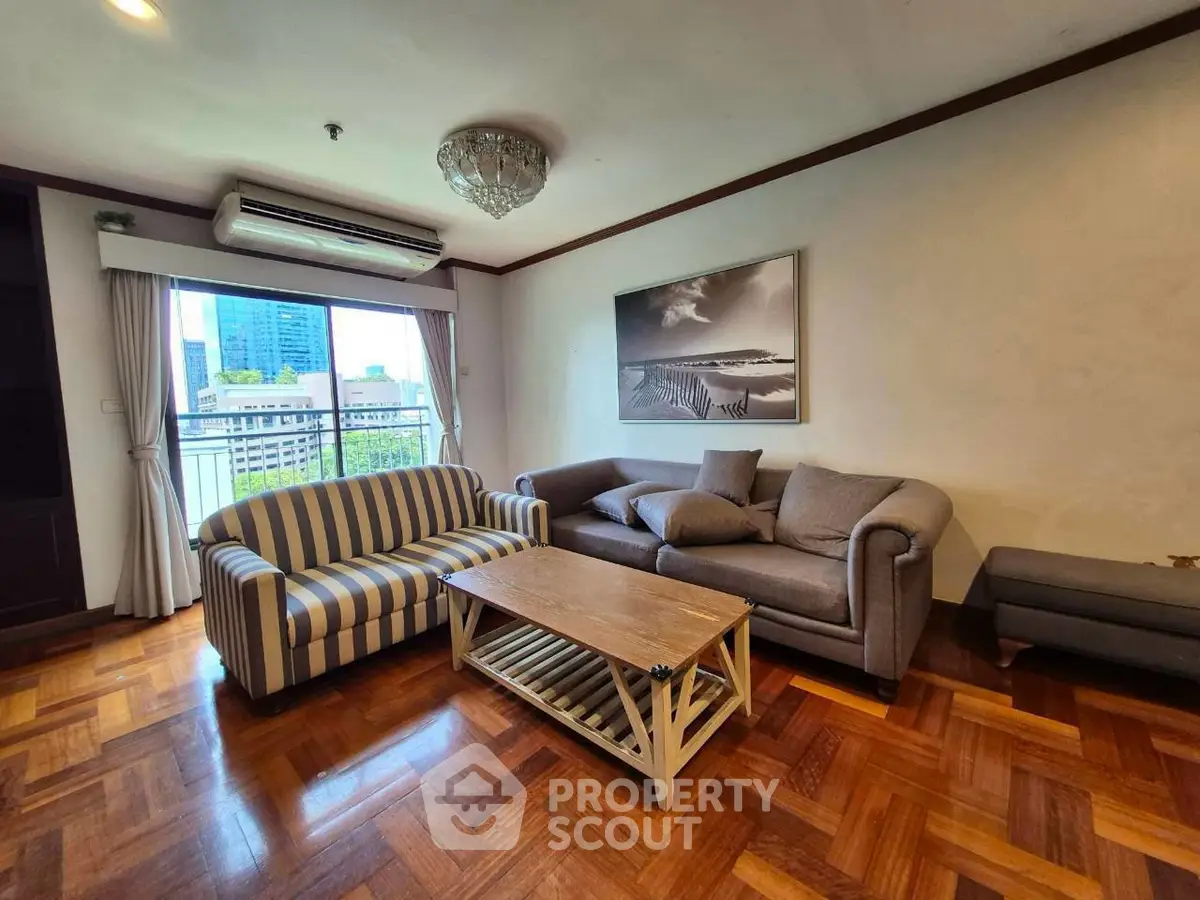 Spacious living room with stylish furniture and city view, perfect for modern urban living.