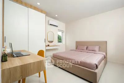 Modern bedroom with minimalist design, featuring a cozy bed, study desk, and natural light.