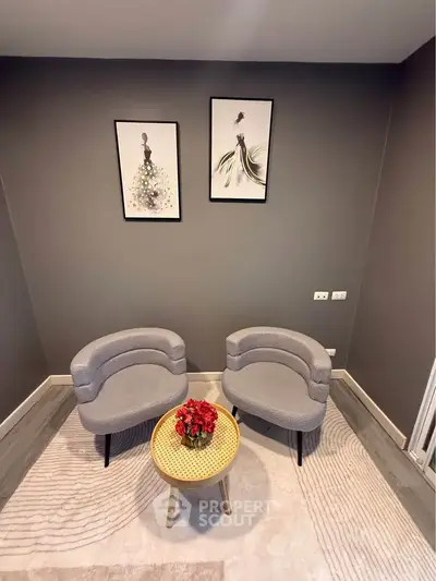 Stylish modern living room with elegant gray chairs and chic wall art, perfect for contemporary urban living.