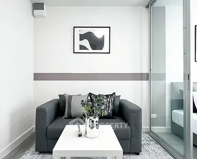Modern living room with sleek gray sofa and stylish decor in a contemporary apartment.